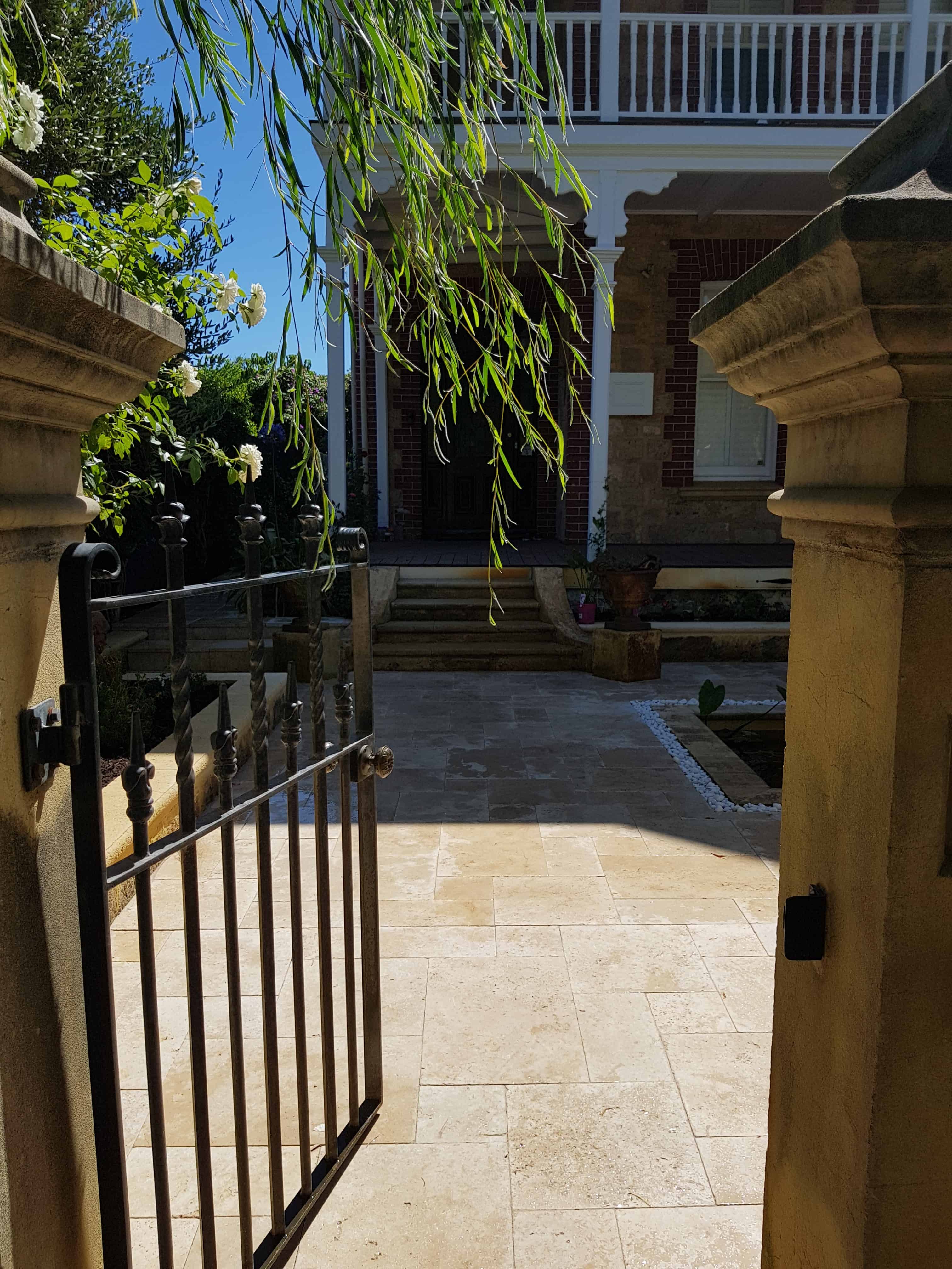 Steel Gate Open at a Classic 2 Storey Home & Front Yard Landscape